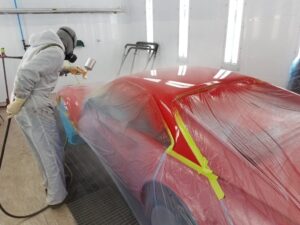 auto body technician in spray booth